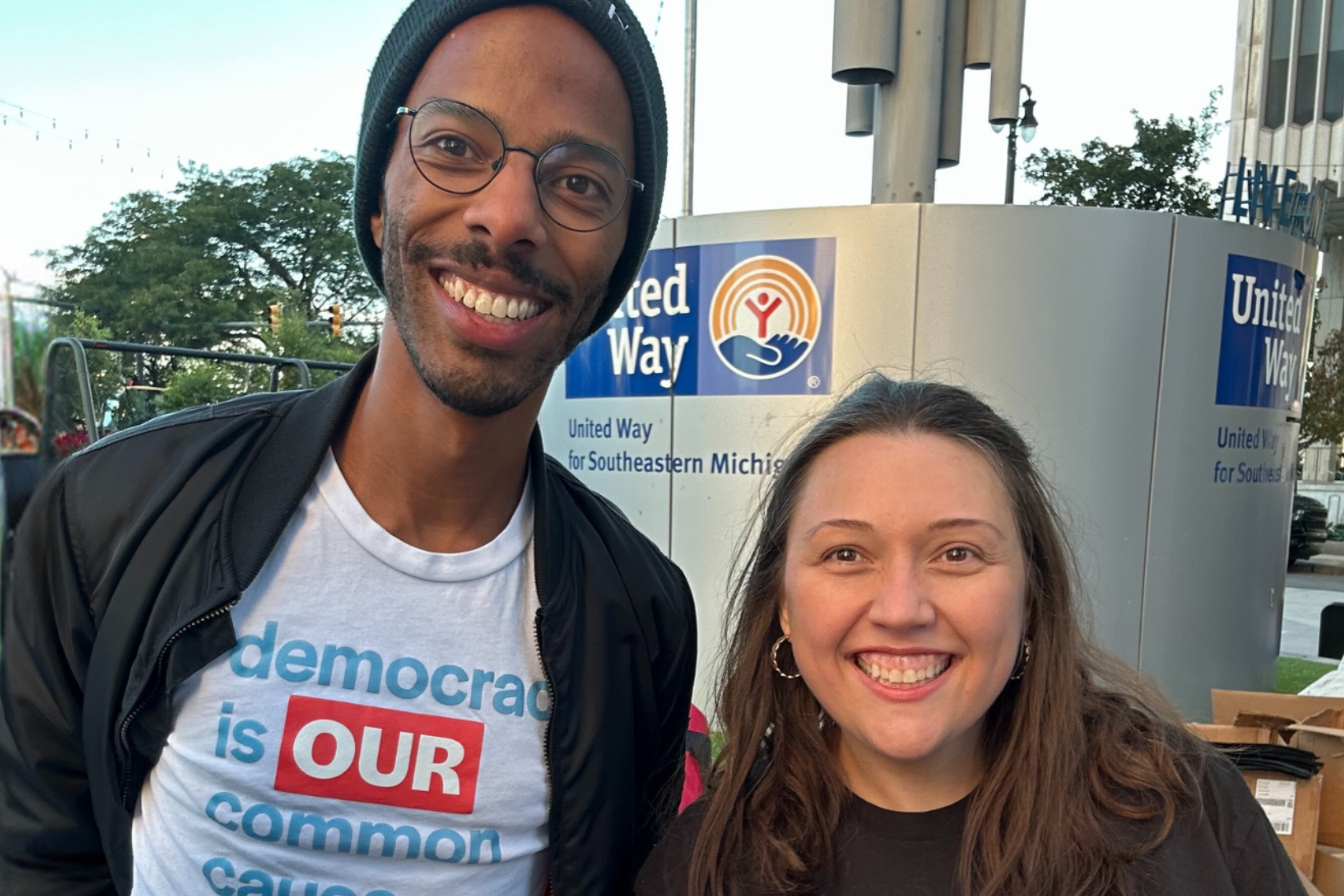 Image of two Common Cause Michigan staff members at an outdoor event.